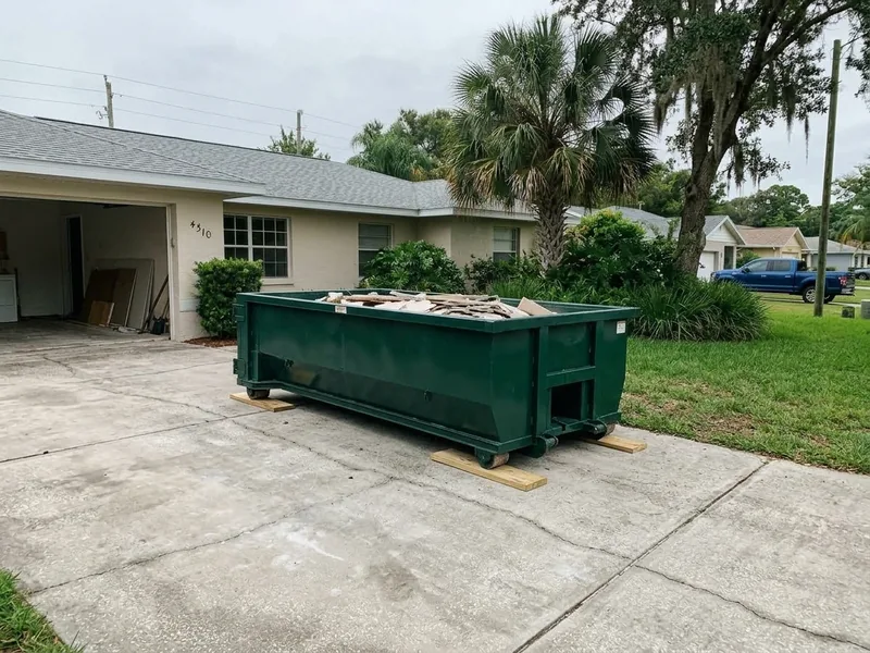 After: Cleaned and swept Florida driveway with roll-off dumpster
