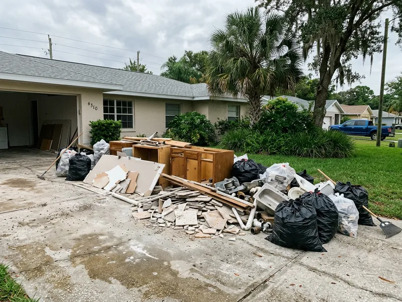 Before: Cluttered Florida driveway with renovation debris